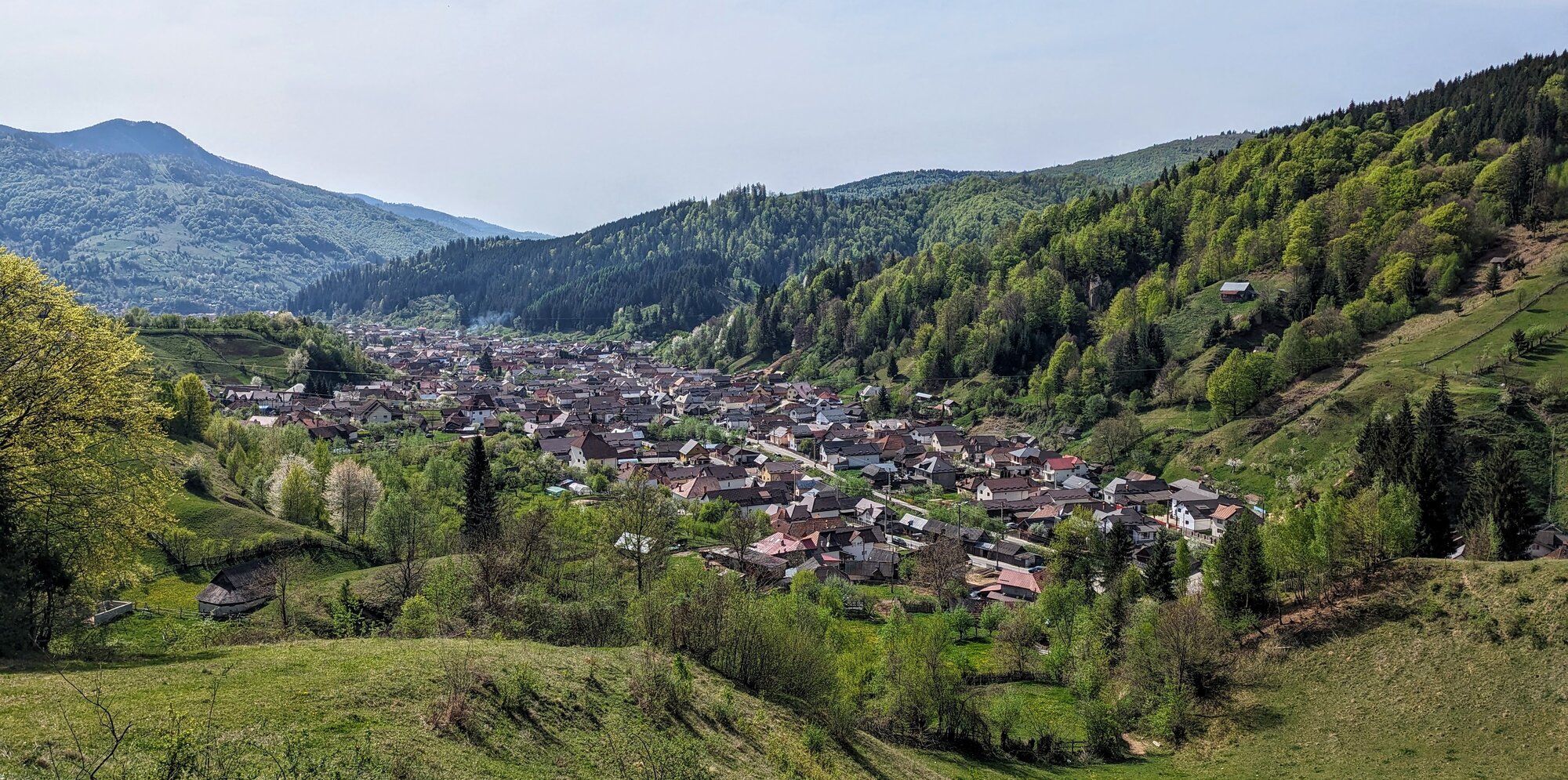 Rucăr village and forested hills in the Southern Carpathians under a stormy sky